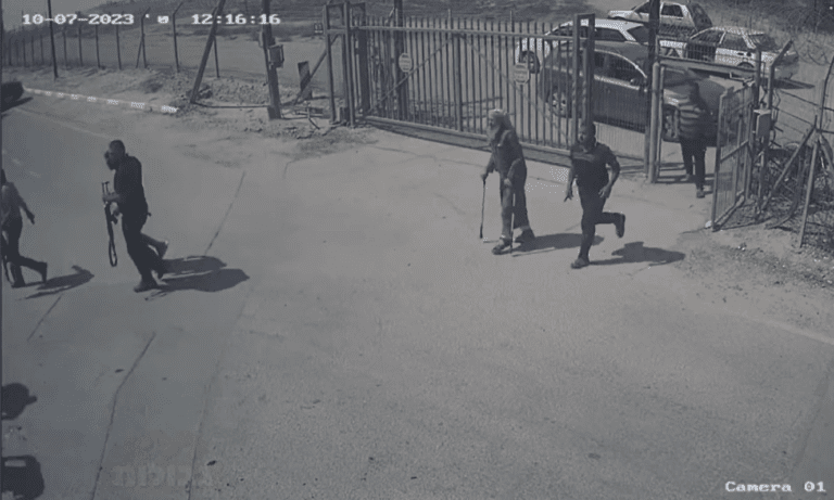 Surveillance footage showing armed individuals and an elderly man with crutches at a gated entrance.