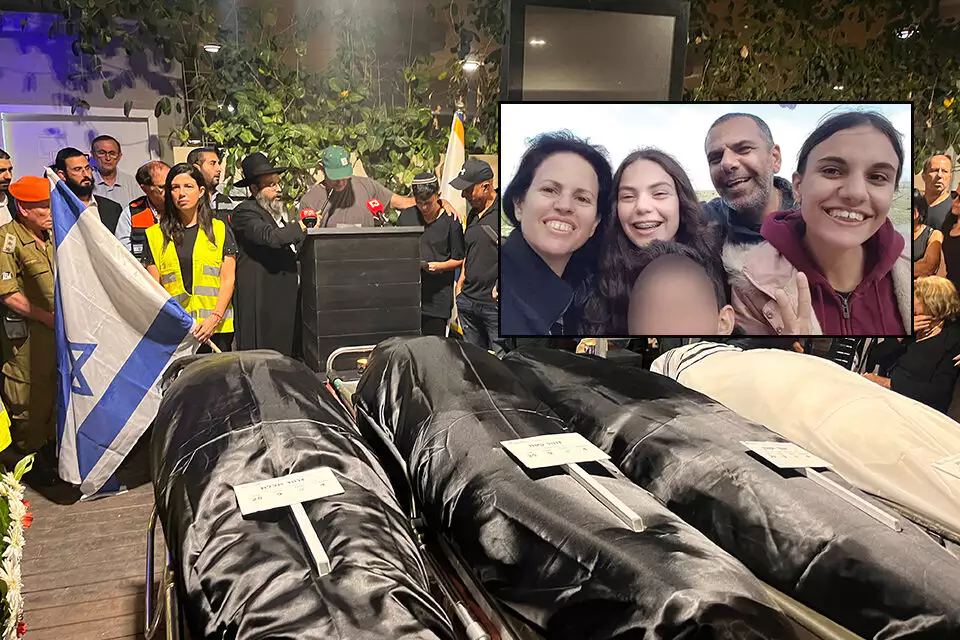 A memorial service for the Zohar family, victims of a Hamas attack, with a young boy named Ariel, the sole survivor, receiving a comforting hand on his shoulder while wearing a yarmulke.