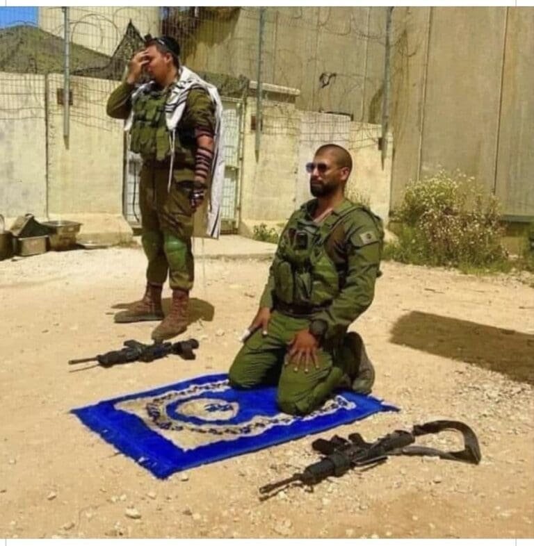 Two soldiers, one praying on a prayer rug and the other standing and praying, both in military attire.