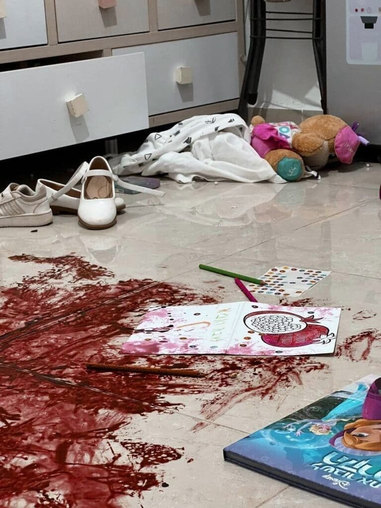 An indoor scene with art supplies and personal items scattered on the floor in a children's room, where the floor covered in blood a silent evidence for the horror that took place when Hamas came.