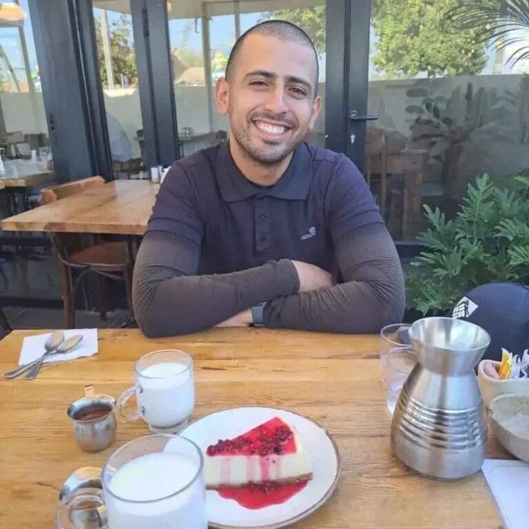 Ariel Bilya sits smiling at a table, his positive spirit oblivious to the impending tragedy that will take his life in the Hamas-initiated war on Israel.